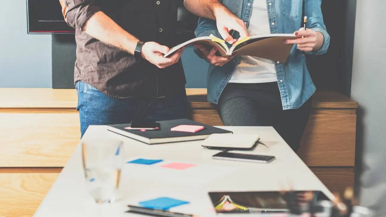 a person speaks to a designer about marketing or advertising costs