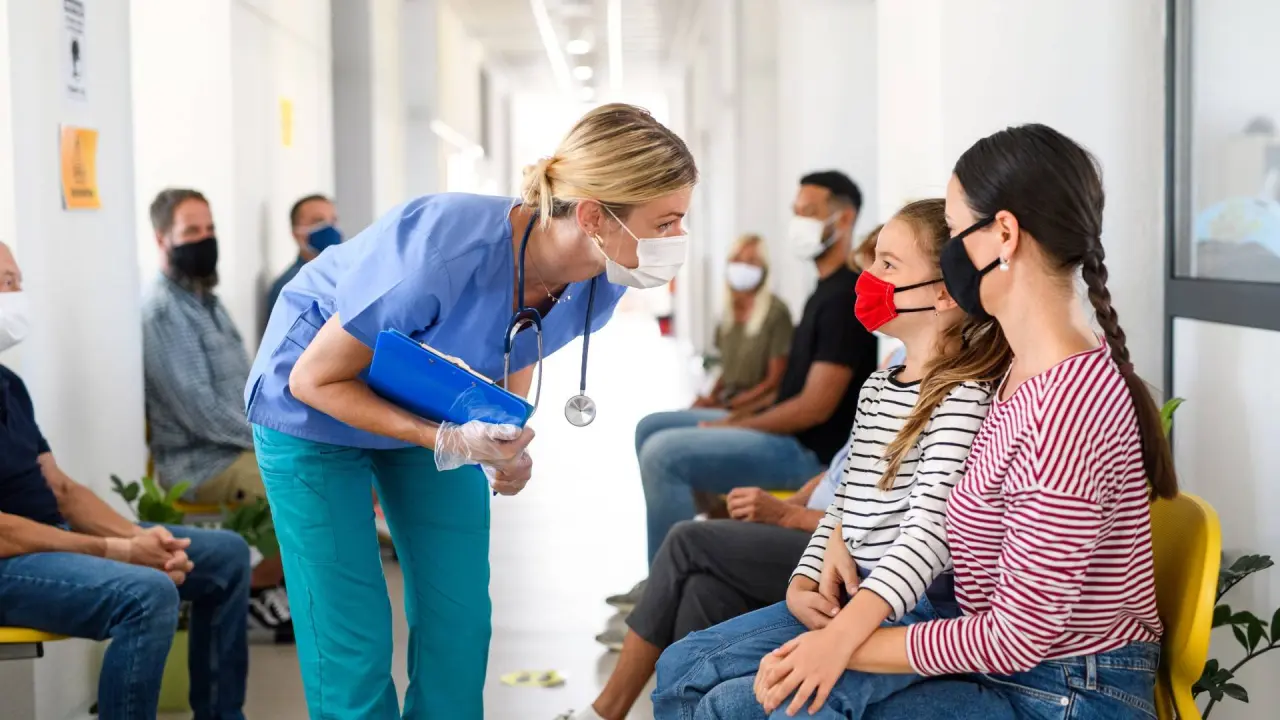 a dentist takes a look at the patient numbers in a waiting room