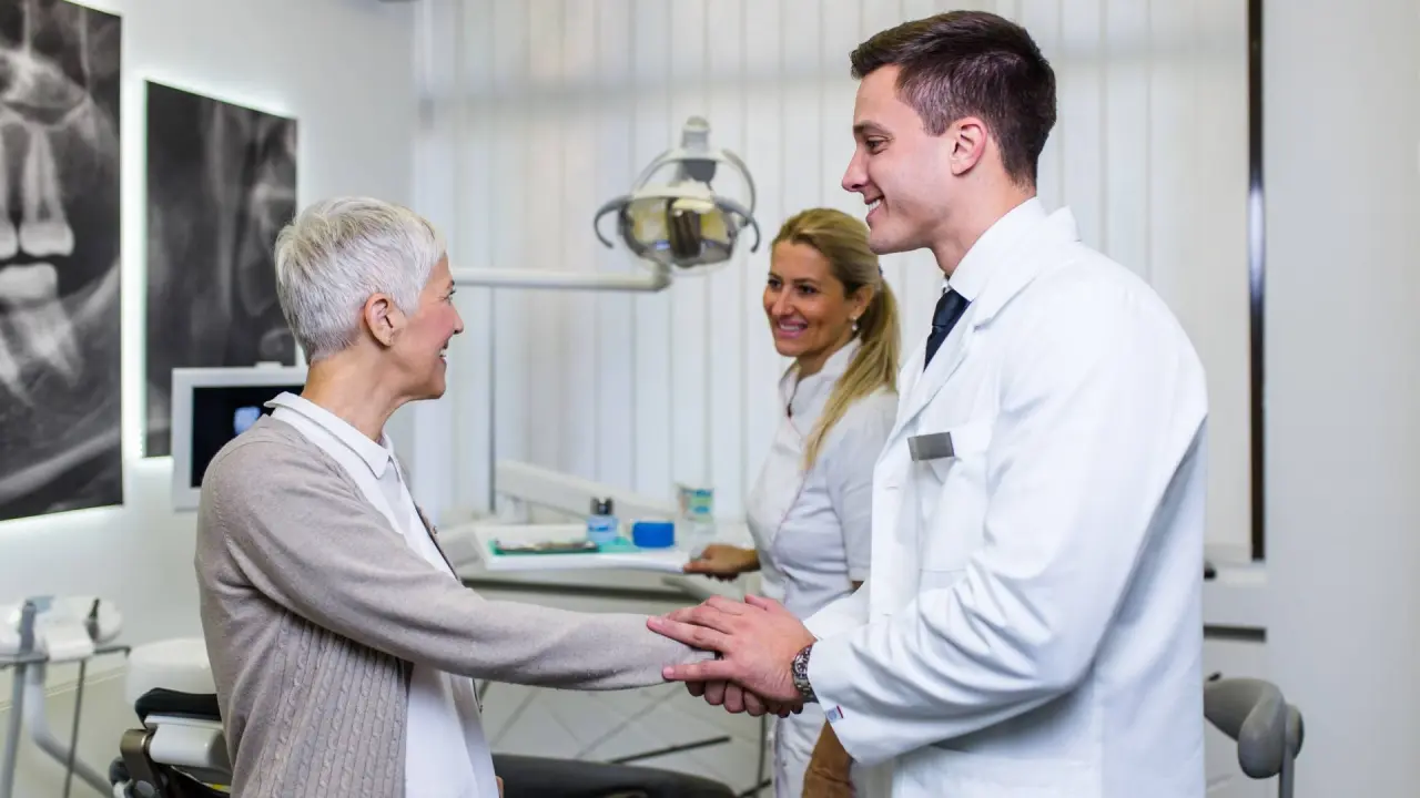 an older dentist sells their practice to younger dentists