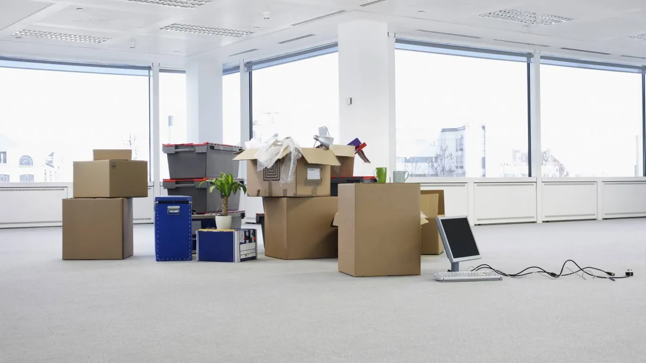 boxes of equipment sit in an empty office space to show the reasons for selling a dental practice