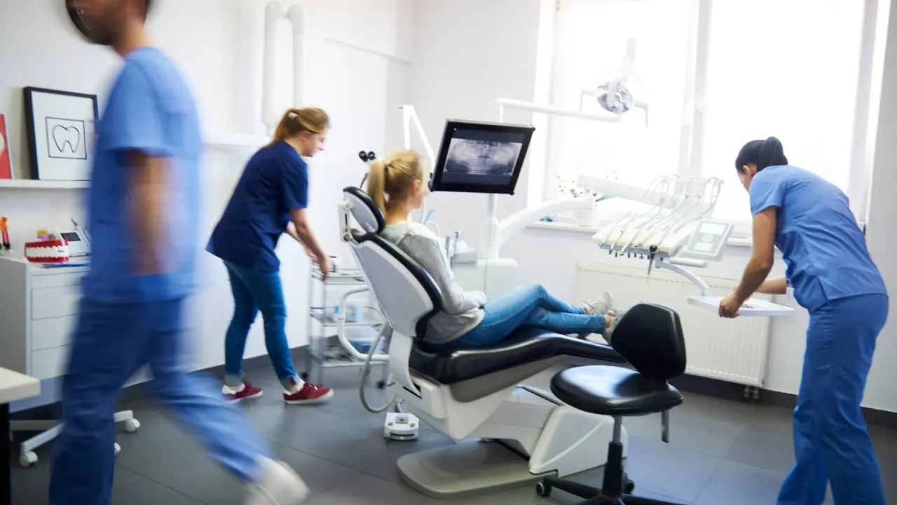 dentists and a patient gathers in the office